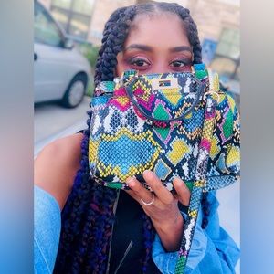 Faux snakeskin mini hand bag.